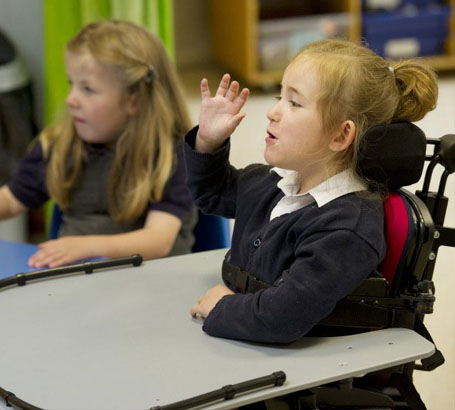 Teacher interacting with a disabled girl