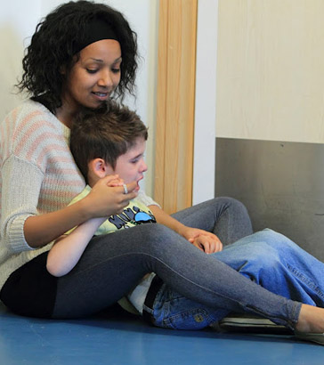 Teacher comforting a boy