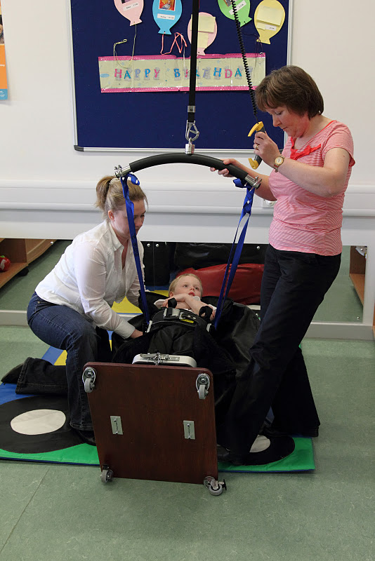 A boy being lifted in a hoist