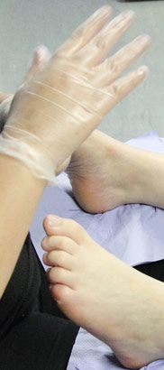 A girl receives physiotherapy on her feet