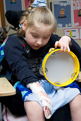 A girl and her teacher with a small
                  tambourine