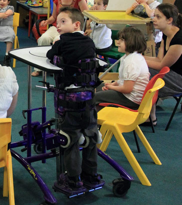 A boy in a standing frame