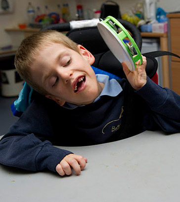 A boy with a small tambourine