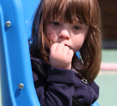 A girl sitting in a playground