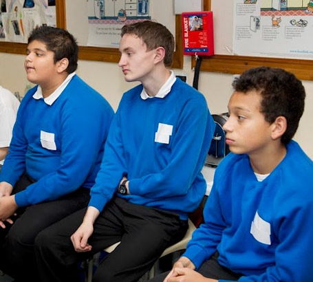 Three boys listening.