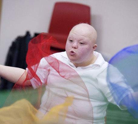 Boy throwing a net in front of
                  his face