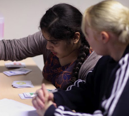 Teacher helping a girl