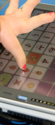 Child using AAC device.