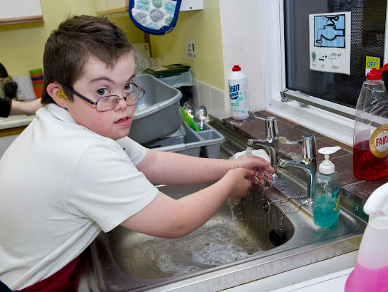 Carer comforts a distressed boy.