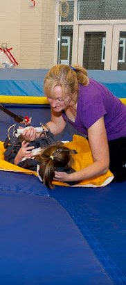 Teacher with a girl on a trampoline