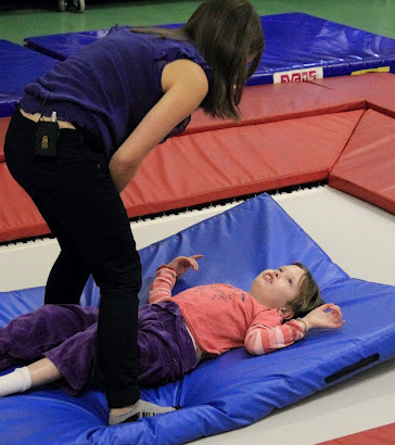 Girl on a trampoline with a teacher