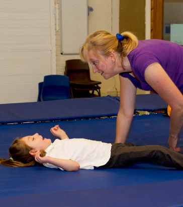 Girl on a trampoline with a teacher