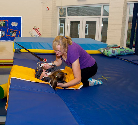 Teacher with a girl on a trampoline