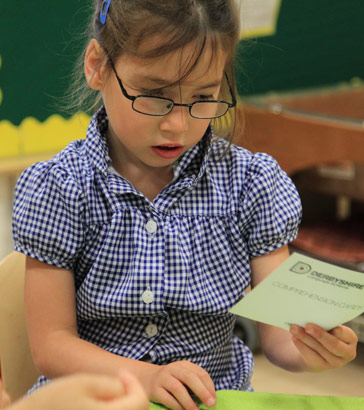 A girl looks at a card