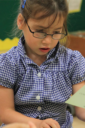 A girl looks at a card