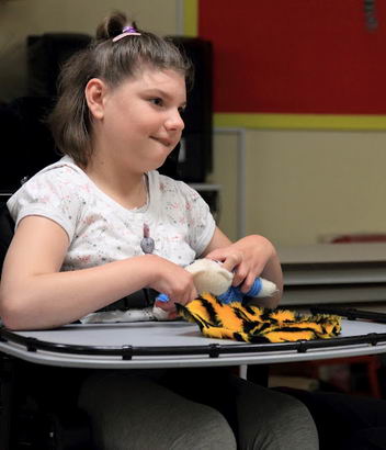 A girl touches different materials