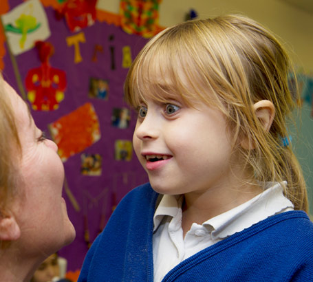 A girl and her teacher with some communication cards