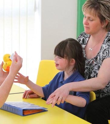 Two teachers, a girl and a toy duck