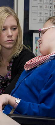 A girl and her teacher work through a sequence of instructions