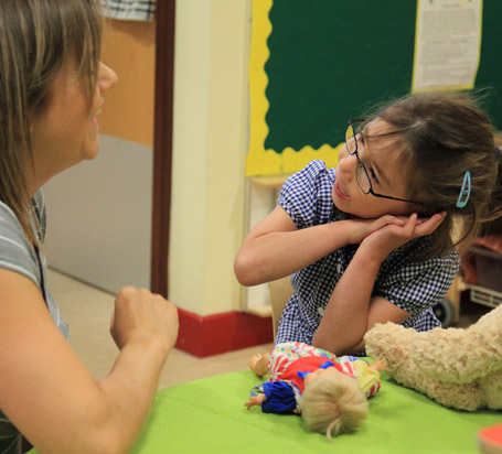 A girl speaking to her teacher