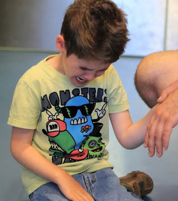 An upset boy with his teacher