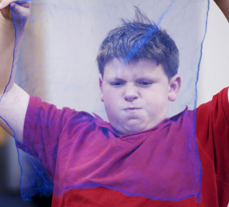 Boy holding a net in front of his face