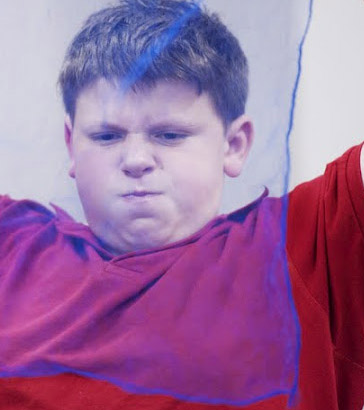 Boy holding a net in front of his face